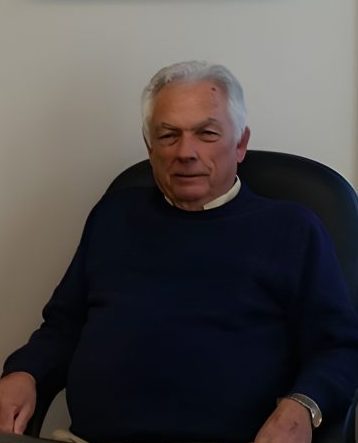 A photo of Gord Mason, sitting at his desk